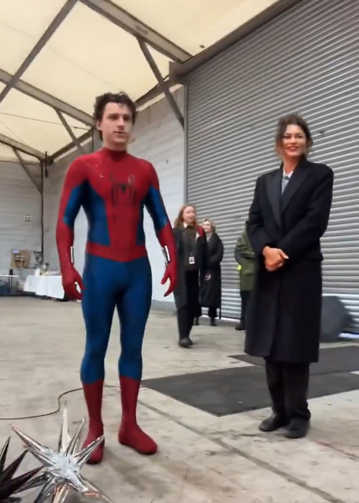 Tom Holland in Spider-Man suit standing beside Zendaya in black coat on set, sparking leaked video pregnancy rumors. Tom Holland in Spider-Man suit standing beside Zendaya in black coat on set, sparking leaked video pregnancy rumors.