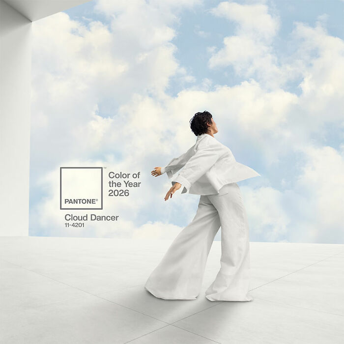 Person in white outfit posing against a cloudy sky background with Pantone’s Color of the Year 2026 Cloud Dancer. Person in white outfit posing against a cloudy sky background with Pantone’s Color of the Year 2026 Cloud Dancer.
