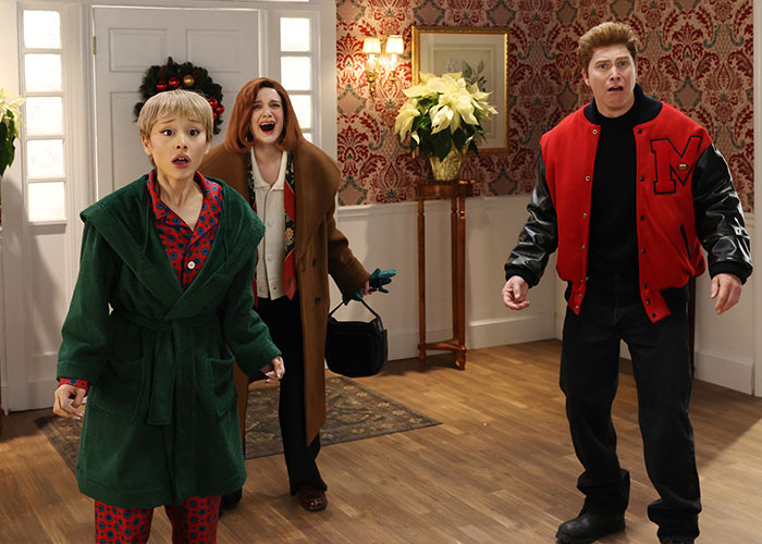 SNL Home Alone parody scene with Ariana Grande and cast reacting in a room with vintage wallpaper and holiday decor. SNL Home Alone parody scene with Ariana Grande and cast reacting in a room with vintage wallpaper and holiday decor.