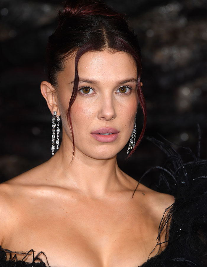 Millie Bobby Brown with subtle makeup and elegant earrings attending an event sparking fan theories about Jake Bongiovi control Millie Bobby Brown with subtle makeup and elegant earrings attending an event sparking fan theories about Jake Bongiovi control