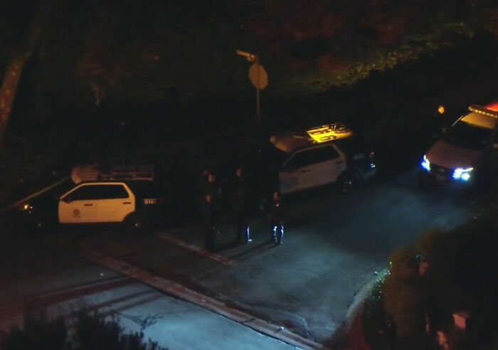 Police officers stand near patrol cars at night, highlighting MAGA hypocrisy in Rob Reiner and Charlie Kirk comparisons. Police officers stand near patrol cars at night, highlighting MAGA hypocrisy in Rob Reiner and Charlie Kirk comparisons.