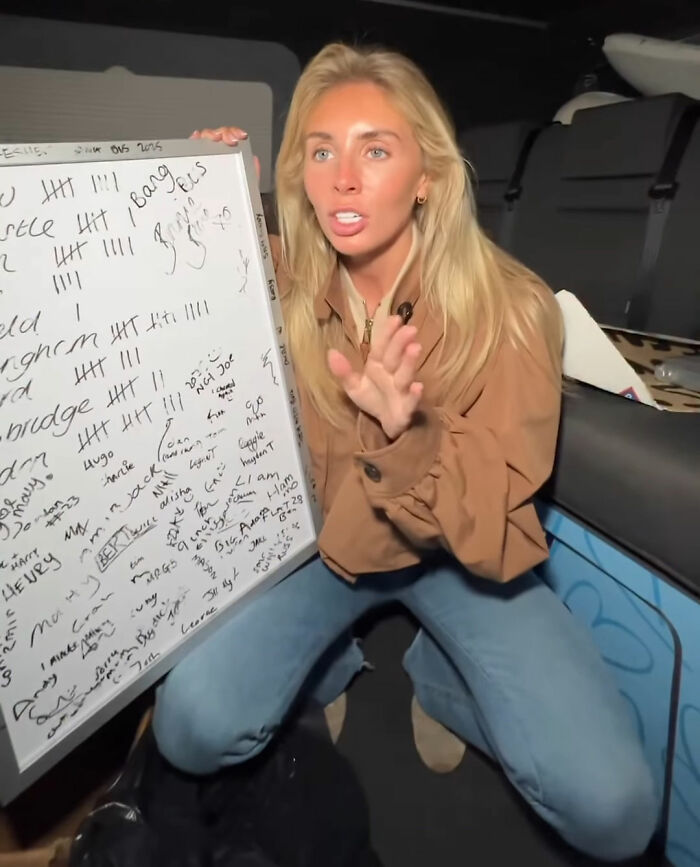 Woman holding a whiteboard covered in notes, explaining Bonnie Blue's fate after arrest related to controversial video incident. Woman holding a whiteboard covered in notes, explaining Bonnie Blue's fate after arrest related to controversial video incident.