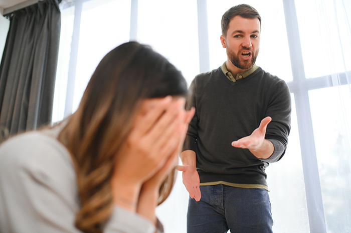 Man expressing frustration while wife covers her face, illustrating marriage falling apart due to ATM machine treatment. Man expressing frustration while wife covers her face, illustrating marriage falling apart due to ATM machine treatment.