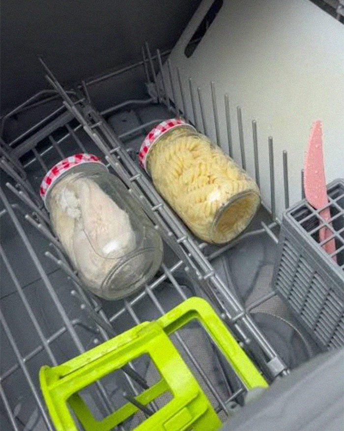 Two jars filled with pasta and food placed inside a dishwasher, illustrating cooking food in the dishwasher concept. Two jars filled with pasta and food placed inside a dishwasher, illustrating cooking food in the dishwasher concept.