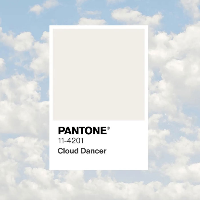 Pantone Cloud Dancer color swatch displayed against a cloudy sky background highlighting the controversial Color of the Year. Pantone Cloud Dancer color swatch displayed against a cloudy sky background highlighting the controversial Color of the Year.