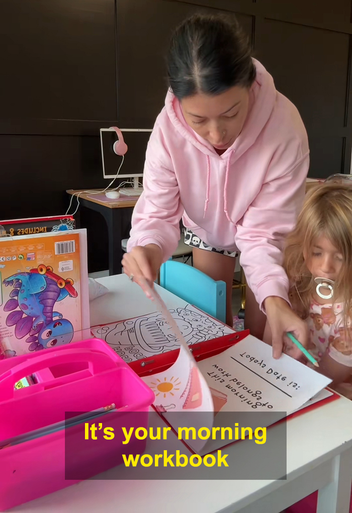 Adult helping child with homeschool workbook at a table, highlighting viral homeschool clip raising questions about parenting choices.