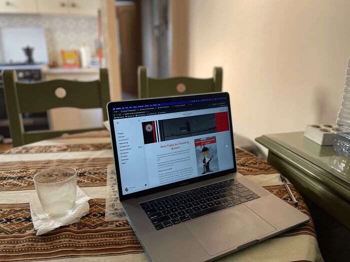 Laptop on a patterned table in a home setting showing digital nomad lifestyle insights on the screen.
