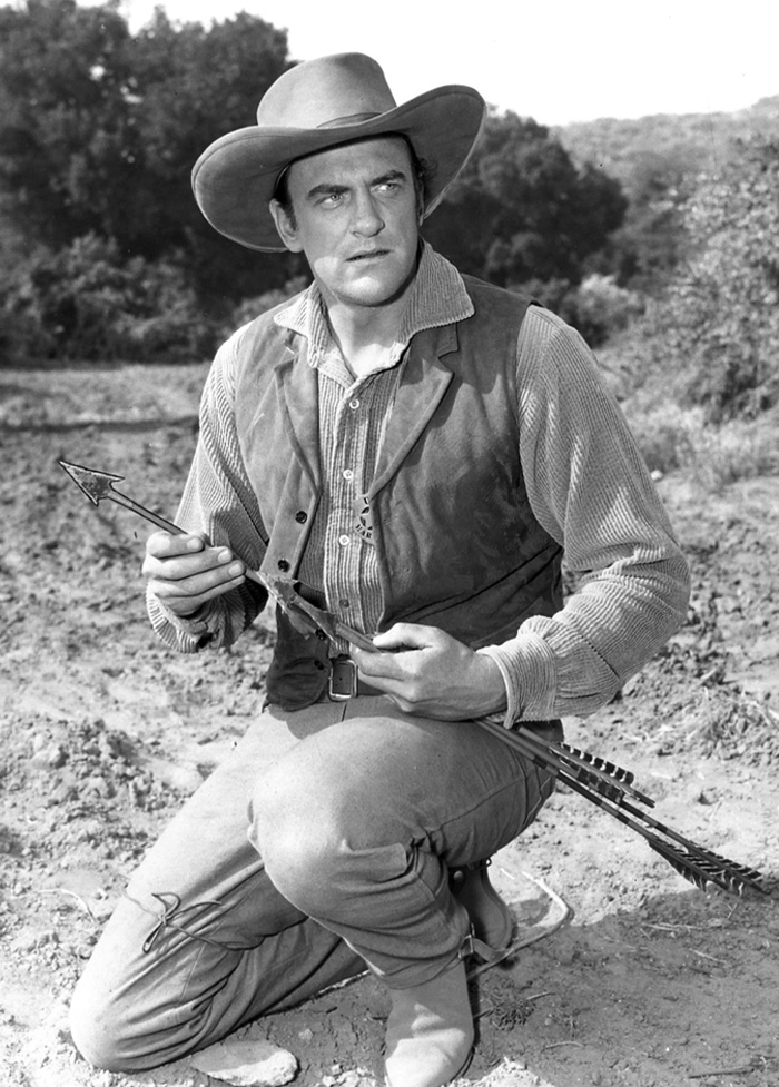 Black and white photo of a cowboy holding an arrow, representing classic TV shows from the longest running TV shows list.