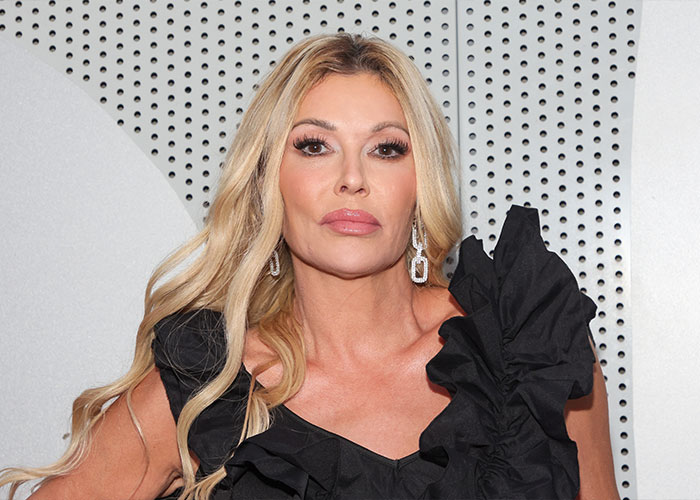 Brandi Glanville posing at event, showcasing bold look after face disfigurement diagnosis and psychosis on display. Brandi Glanville posing at event, showcasing bold look after face disfigurement diagnosis and psychosis on display.
