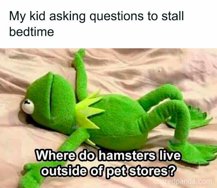 Green Kermit puppet lying on bed representing funny and savage parenting memes about kids stalling bedtime with questions.