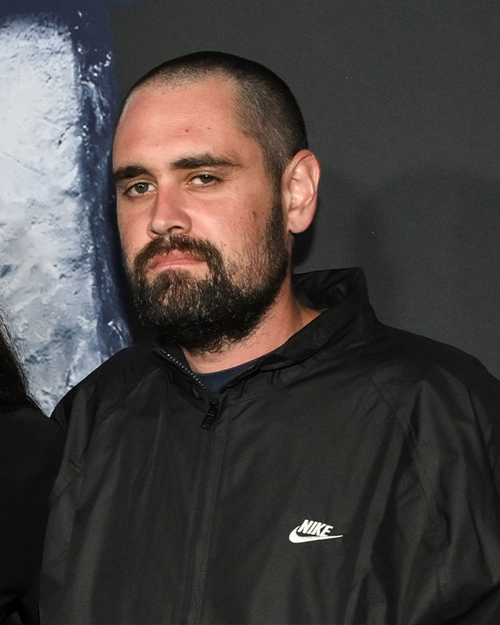 Man with beard and short hair wearing a black Nike jacket, related to Nick Reiner startling diagnosis and erratic behavior.