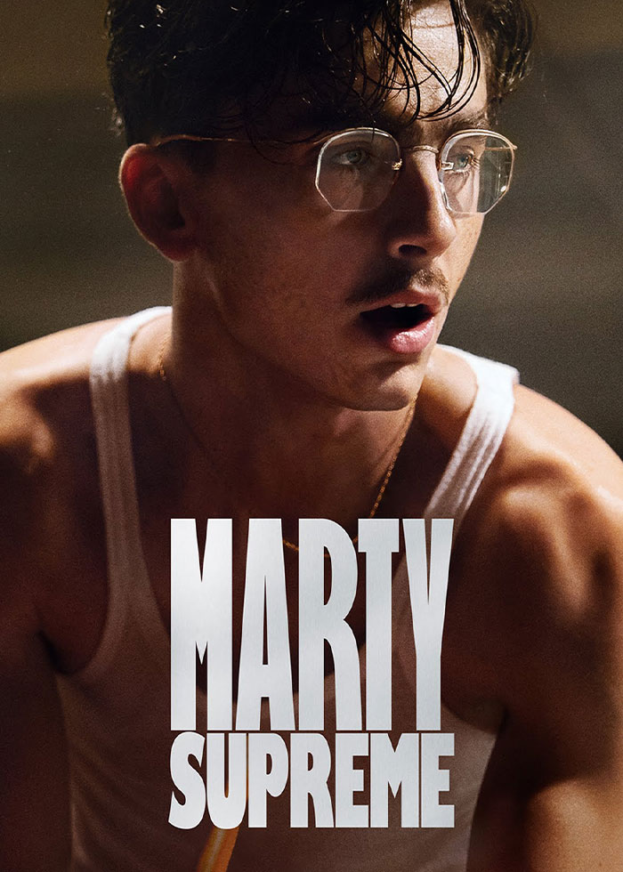 Young man with glasses and wet hair wearing a tank top, highlighted in a dramatic close-up portrait.