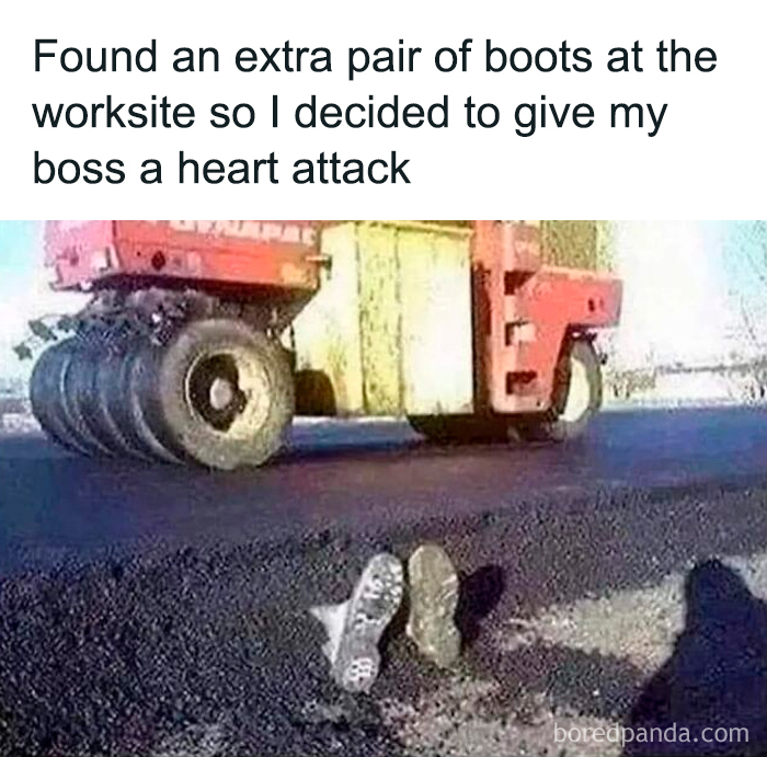 Pair of boots placed under large road roller machine as a funny meme for dark and cold winter days.