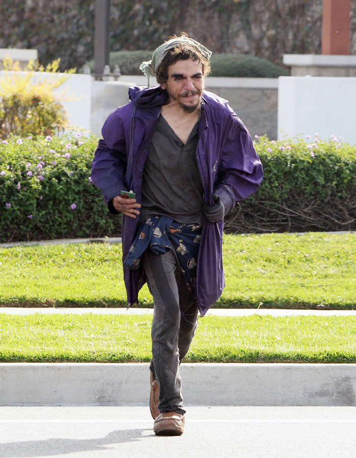 Man in worn clothes walking outdoors, highlighting dad of Nickelodeon star Tylor Chase experiencing life on the streets. Man in worn clothes walking outdoors, highlighting dad of Nickelodeon star Tylor Chase experiencing life on the streets.