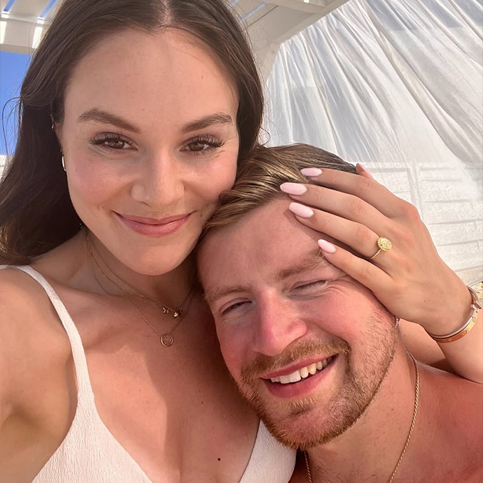 A happy couple smiling closely together with natural light highlighting their faces in a casual setting. A happy couple smiling closely together with natural light highlighting their faces in a casual setting.