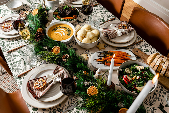 Holiday family dinner table set with festive food and decorations, illustrating a scenario about allergies and family expectations.