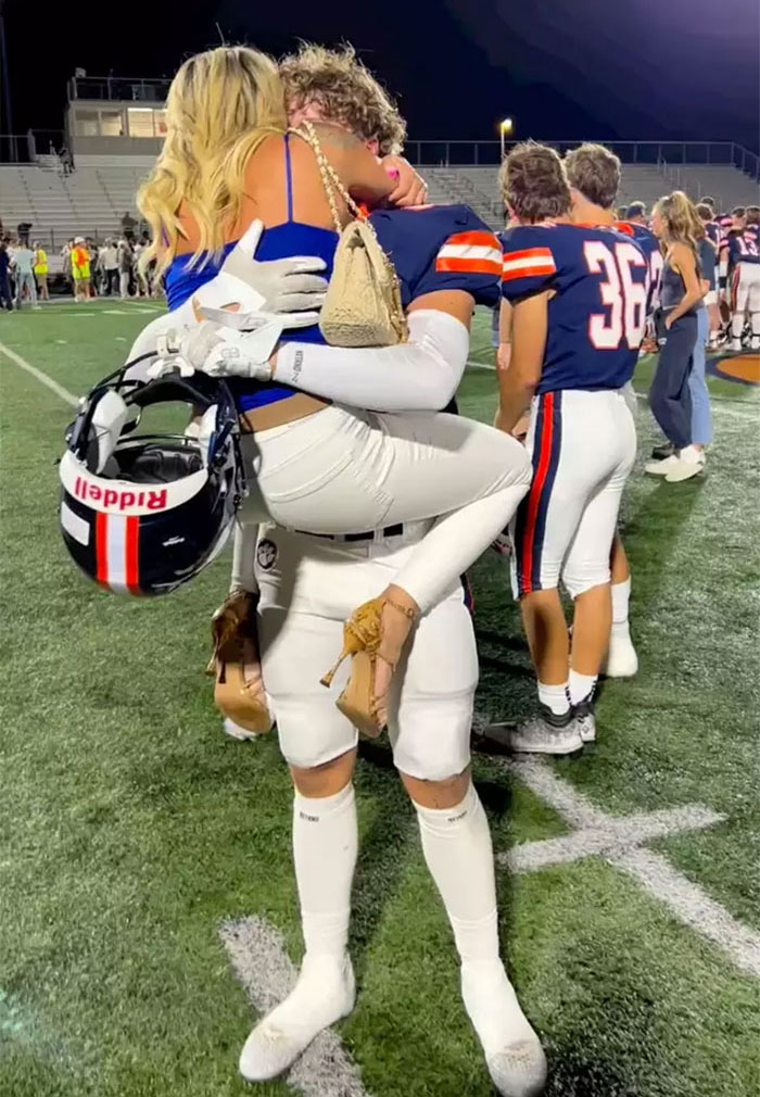 Mother-son photoshoot goes viral showing football player lifting woman on field, sparking heated parenting debate online.