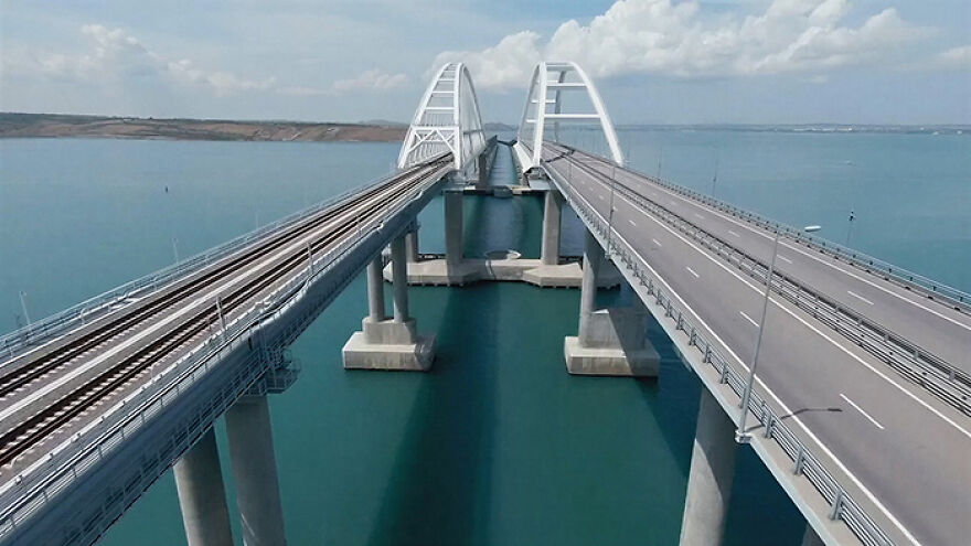Aerial view of remarkable engineering on one of the 12 longest bridges in the world spanning over blue water.