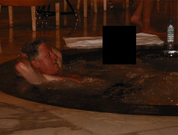 Man relaxing in a dark hot tub with a toddler's foot appearing near him, referencing chilling new files exposed. Man relaxing in a dark hot tub with a toddler's foot appearing near him, referencing chilling new files exposed.