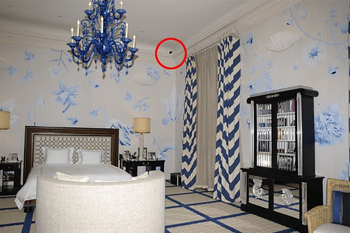 Bedroom interior with blue chandelier and striped curtains, highlighting chilling toddler's foot detail beside Epstein photo files. Bedroom interior with blue chandelier and striped curtains, highlighting chilling toddler's foot detail beside Epstein photo files.