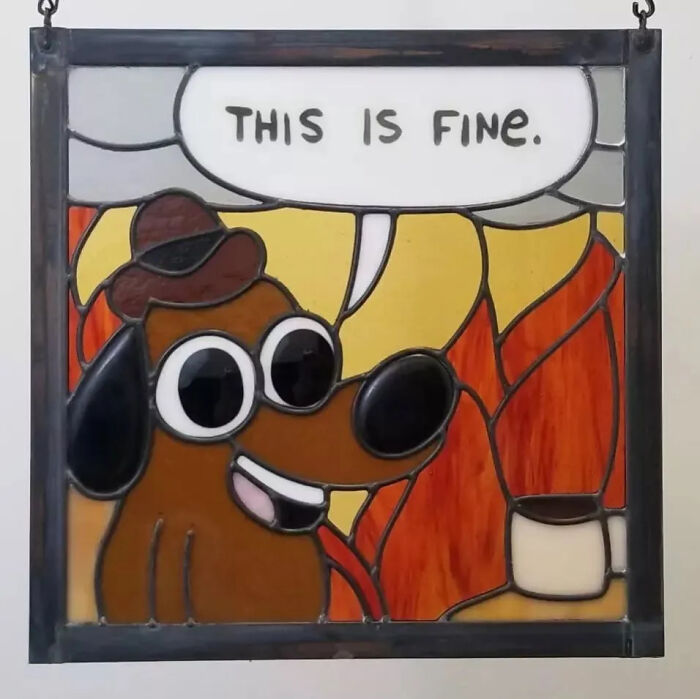 Stained glass sign featuring a pop culture dog icon with speech bubble saying this is fine, vivid colors.