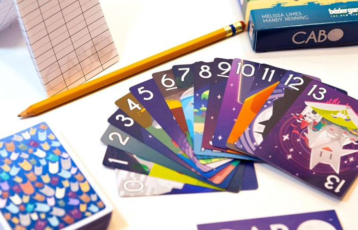 Colorful numbered cards from a popular party game with a pencil and score sheet, showcasing the best party game experience.