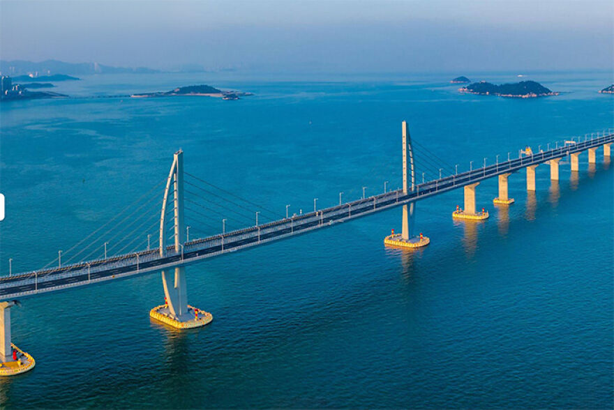 Aerial view of remarkable engineering behind one of the 12 longest bridges in the world over blue ocean water.