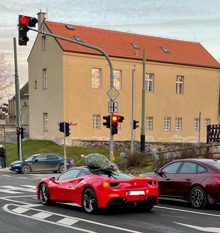 Red Ferrari on street with large cabbage tied on top, a hilarious meme relatable for those who grew up in Eastern Europe.