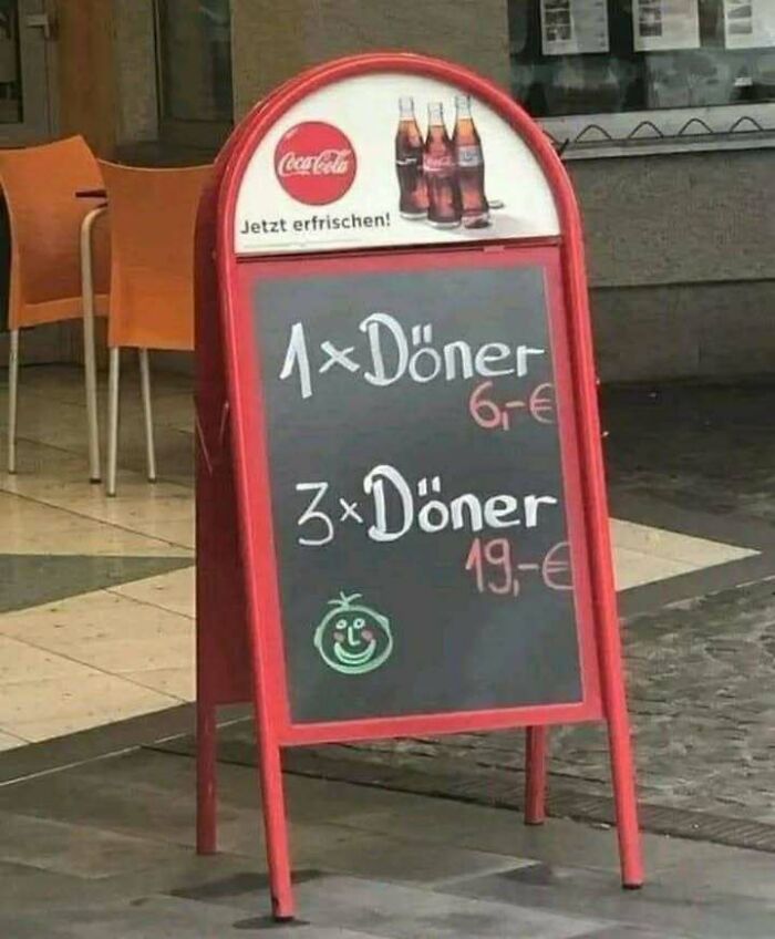 Chalkboard menu outside a restaurant showing döner prices, a humorous sign relatable for those who grew up in Eastern Europe.
