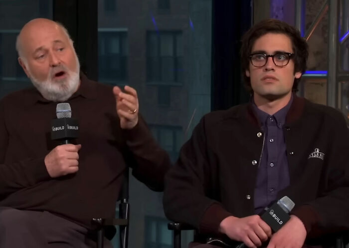 Two men holding microphones during an interview, discussing the horrific state of Nick Reiner's hotel room. Two men holding microphones during an interview, discussing the horrific state of Nick Reiner's hotel room.