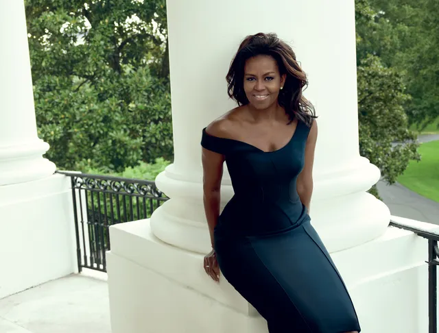 Michelle Obama in a bold new look, posing outdoors in an elegant off-shoulder black dress, praising makeup artist. Michelle Obama in a bold new look, posing outdoors in an elegant off-shoulder black dress, praising makeup artist.