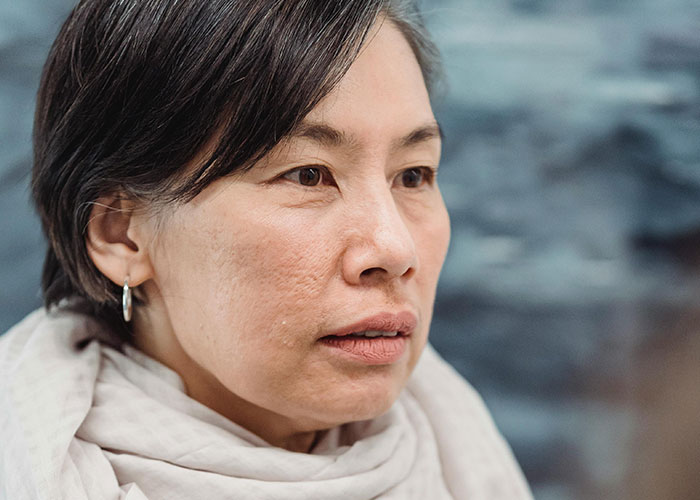 Middle-aged woman looking shocked and concerned, capturing a moment related to unhinged things a MIL said.