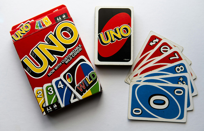 UNO card game box and cards laid out on a white surface, representing the best party game concept.