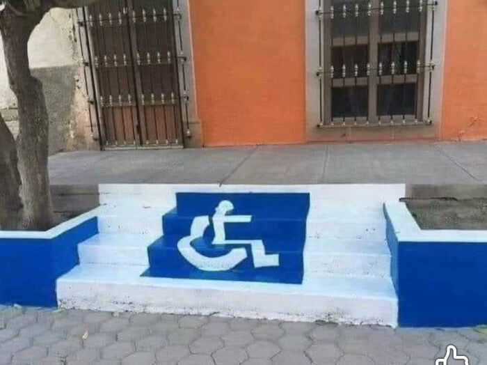 Stairs painted with a distorted wheelchair accessibility symbol as a funny meme for dark and cold winter days.