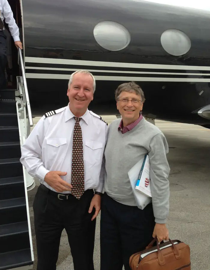 Two men smiling in front of a private jet, related to disturbing Epstein desk photo and new estate images released.
