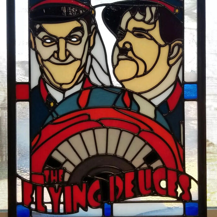 Stained glass art of pop culture icons The Flying Deuces in vivid colors and bold outlines.