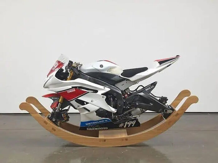 A trippy motorcycle transformed into a rocking bike, blending surreal design with functional elements in an indoor setting.