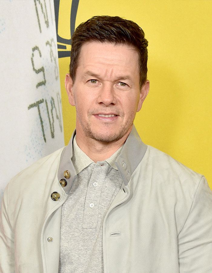 Actor posing against a yellow backdrop, illustrating the theme of outrageous demands actors put in contracts.