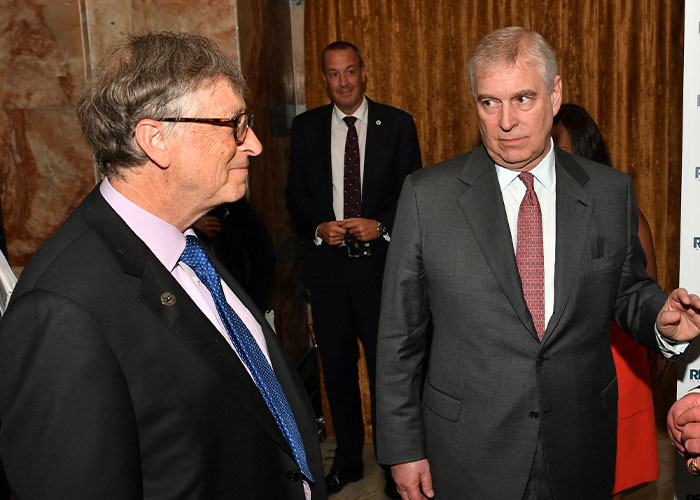 Two men in suits having a conversation at an indoor event, highlighting disturbing Epstein desk photo backlash. Two men in suits having a conversation at an indoor event, highlighting disturbing Epstein desk photo backlash.