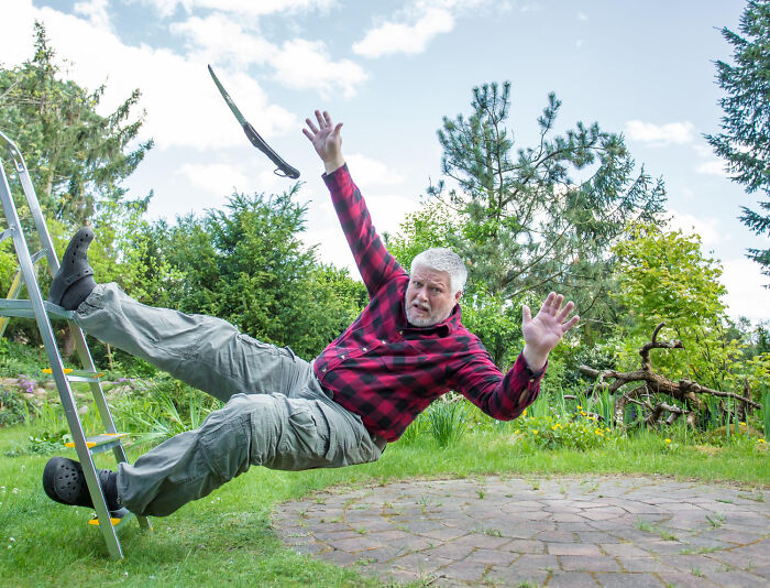 Man falling off a ladder in a garden, illustrating true stories that sound made up but actually happened.