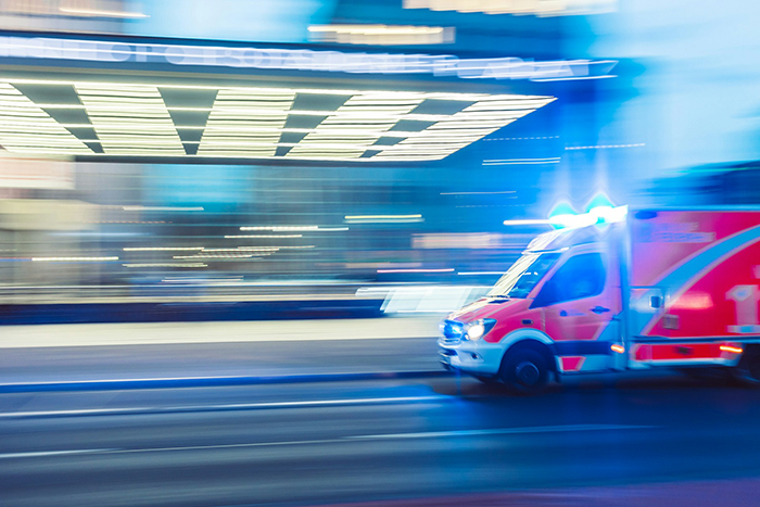 Ambulance rushing at night, representing woman hospitalized after family intervention over obsession with brother. Ambulance rushing at night, representing woman hospitalized after family intervention over obsession with brother.