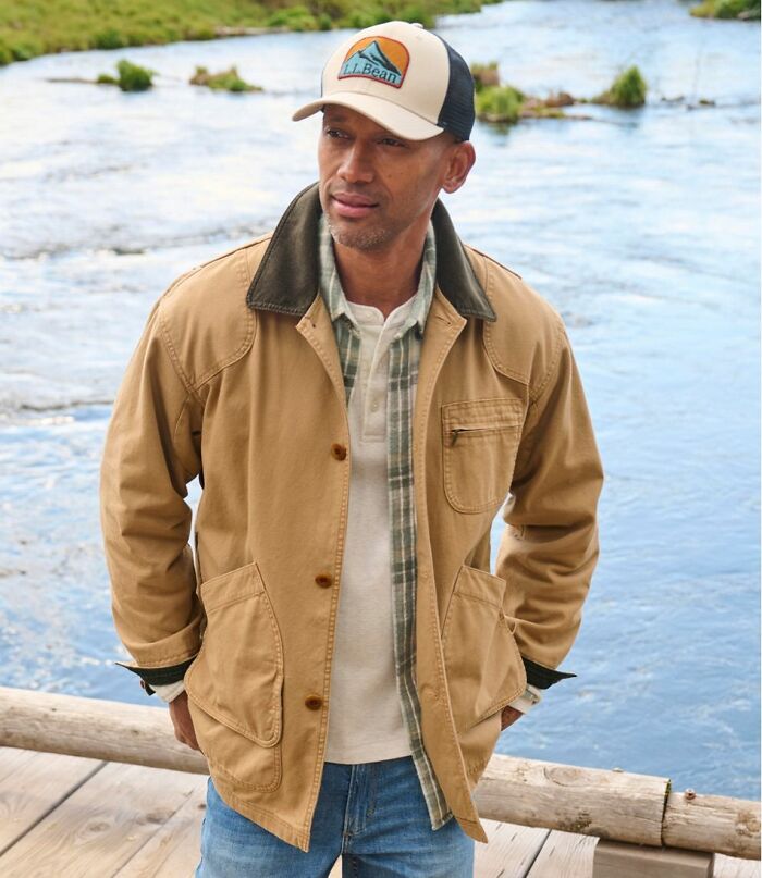 Man wearing a casual jacket and cap near a river, illustrating unusual personal belongings in a lost and found setting.