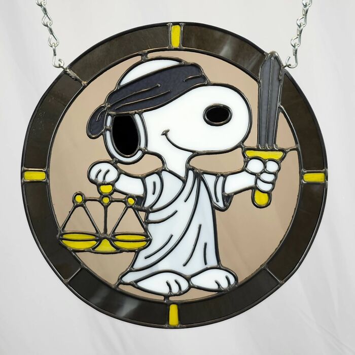 Snoopy pop culture icon crafted as a vivid stained glass sign holding scales and sword.