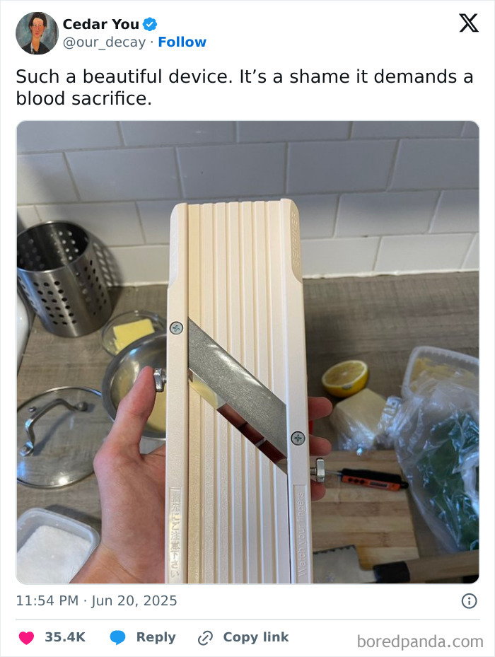 Hand holding a mandoline slicer with a sharp blade, illustrating the humor in food memes about kitchen tools.