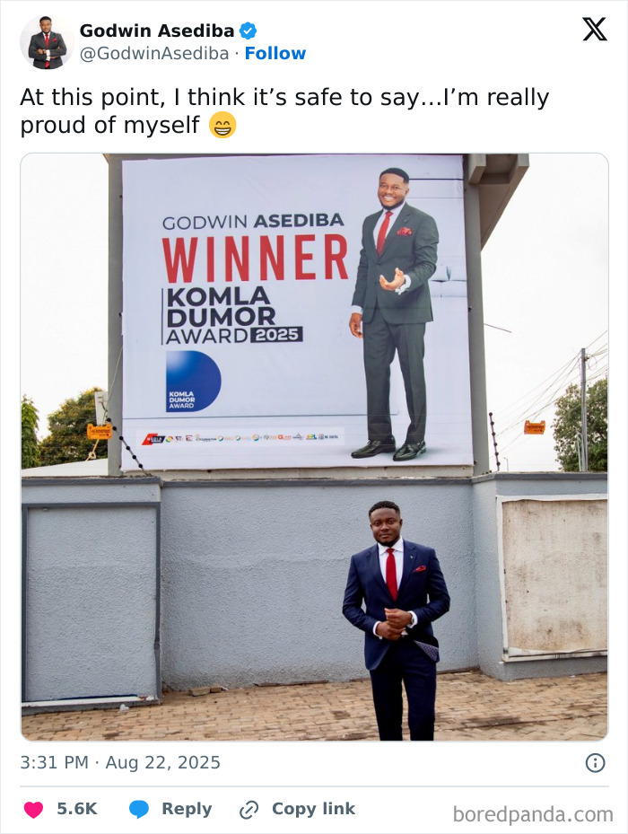 Man in a suit standing proudly below a large billboard celebrating his win, showcasing a leap of faith and best life decisions.