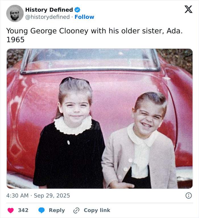 Young George Clooney with his sister Ada in 1965, sharing a heartfelt family moment by a red vintage car. Young George Clooney with his sister Ada in 1965, sharing a heartfelt family moment by a red vintage car.