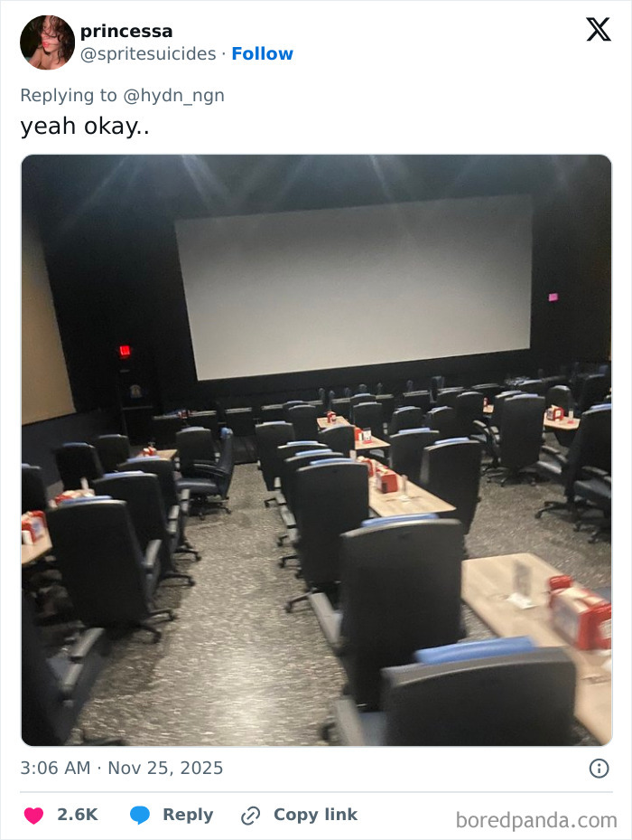 Empty movie theater with swivel chairs and small tables, illustrating one of the worst movie theaters shared by people.