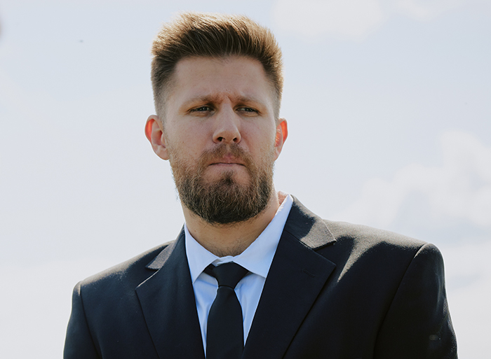 Bearded man in a black suit and tie, looking serious outdoors, reflecting a marriage falling apart after wedding issues. Bearded man in a black suit and tie, looking serious outdoors, reflecting a marriage falling apart after wedding issues.