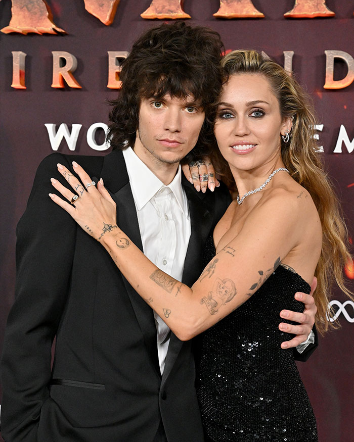 Miley Cyrus and Maxx Morando posing together, showcasing Miley’s youthful glow and viral makeover at an event. Miley Cyrus and Maxx Morando posing together, showcasing Miley’s youthful glow and viral makeover at an event.