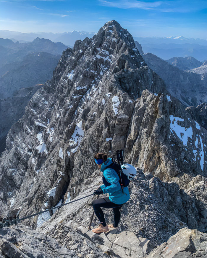 A climber descending a rocky, snowy peak on an Austrian mountain where a woman was abandoned and later found.